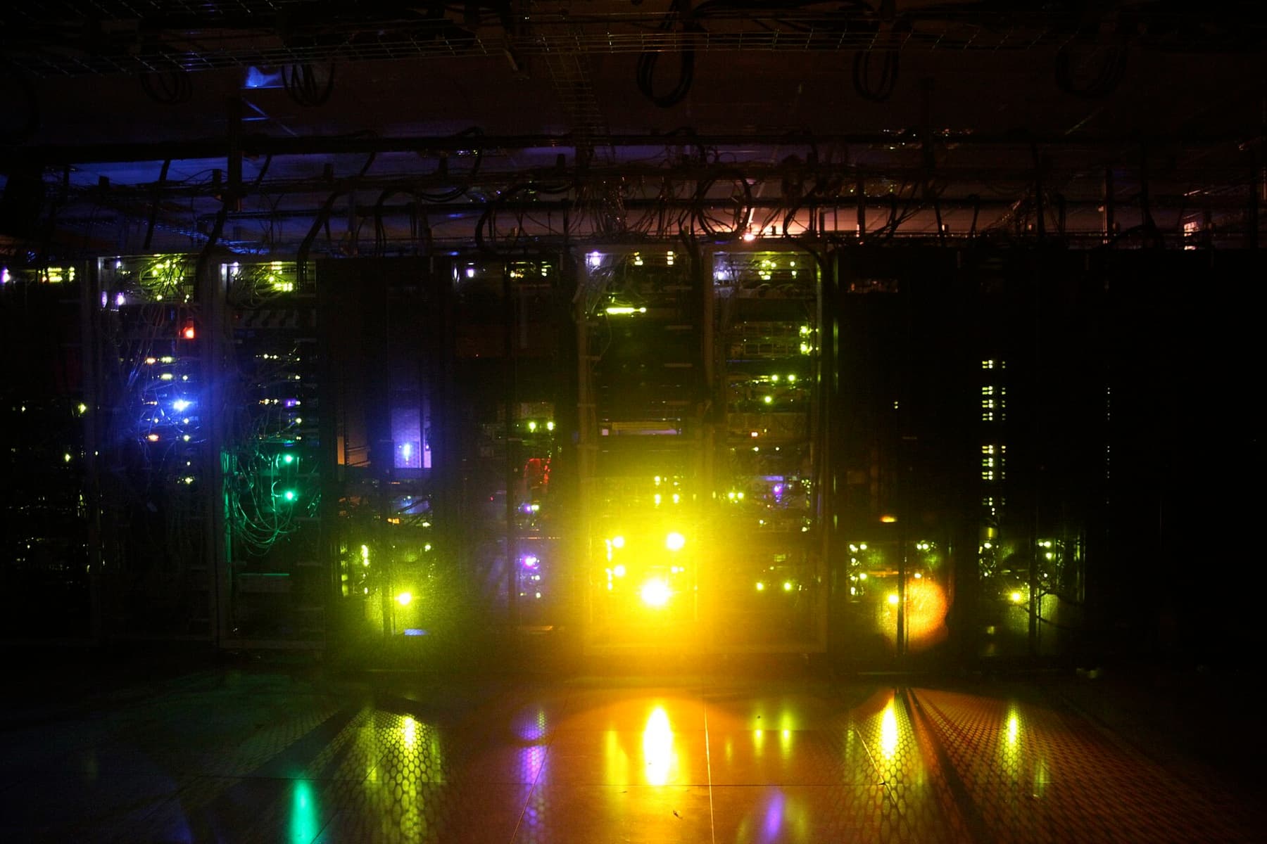 Server racks glowing in a darkened data centre