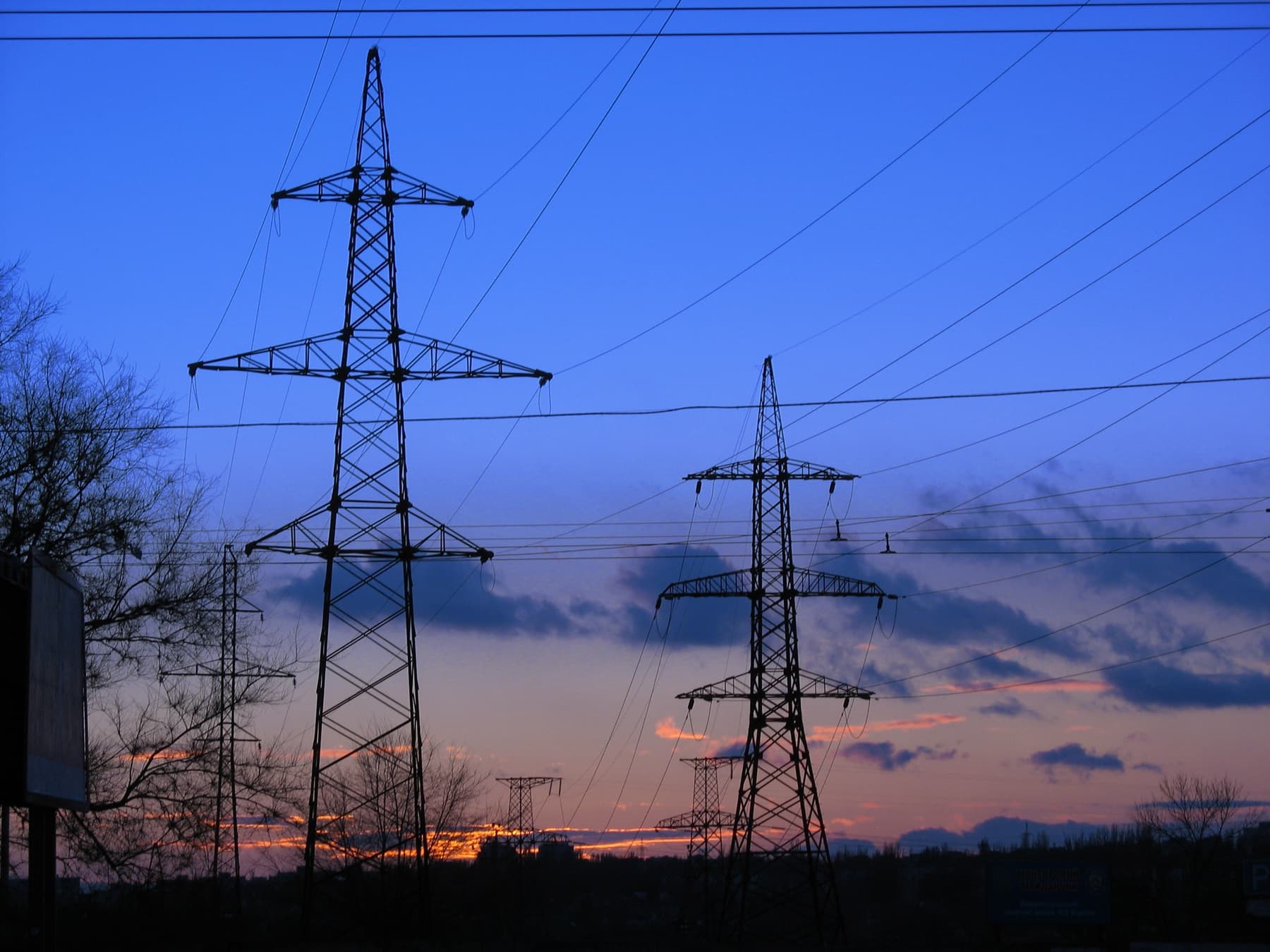 High-voltage transmission towers at dusk