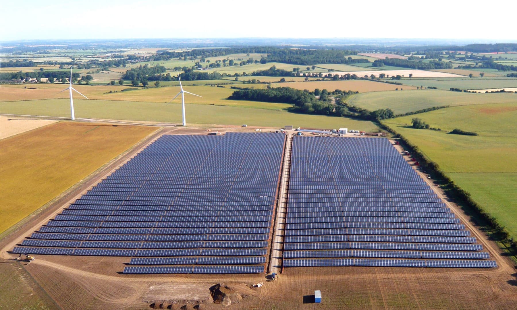 Aerial view of a solar farm amid farmland